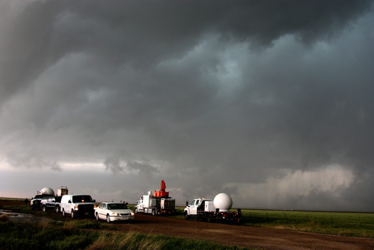 white van on green grass field under gray cloudy sky