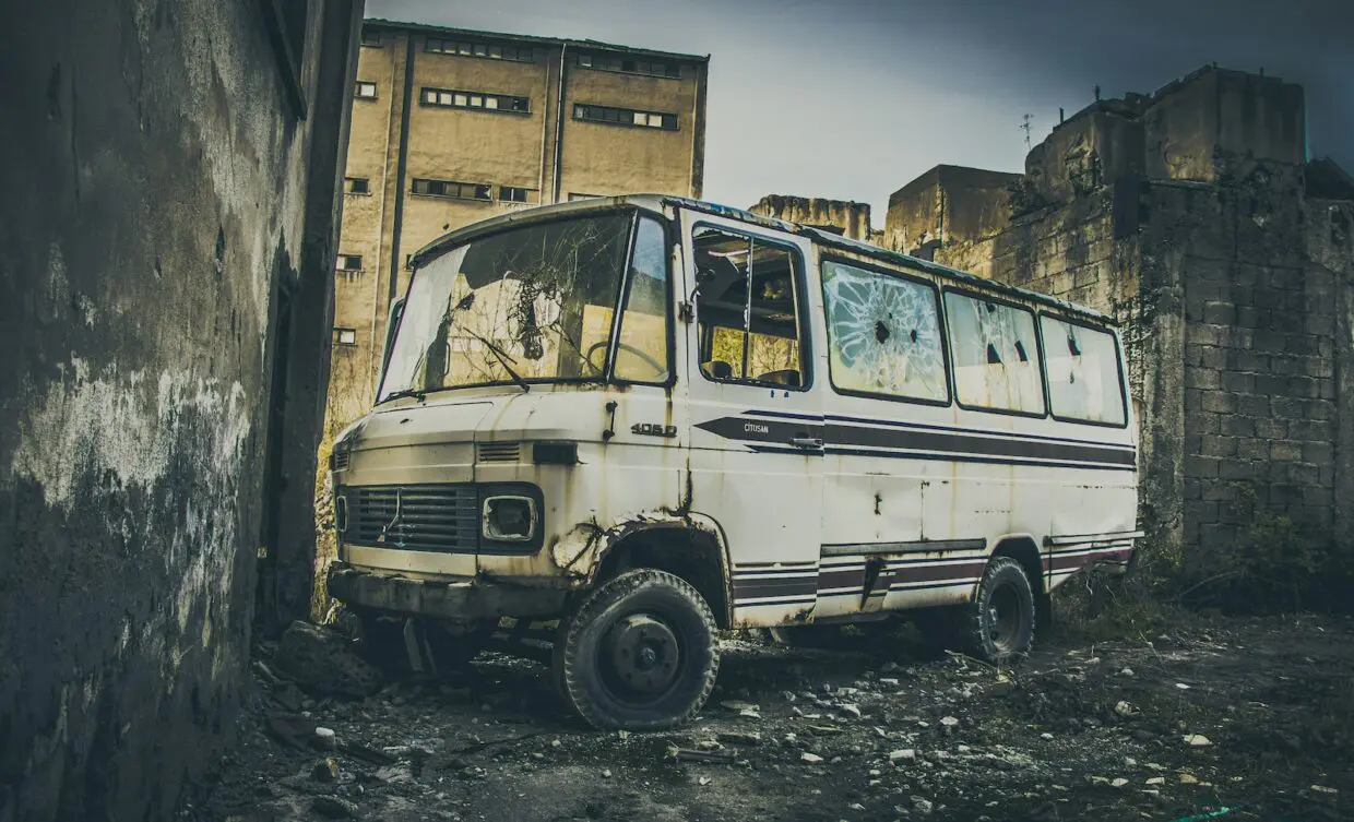 a white van parked in front of a stone building